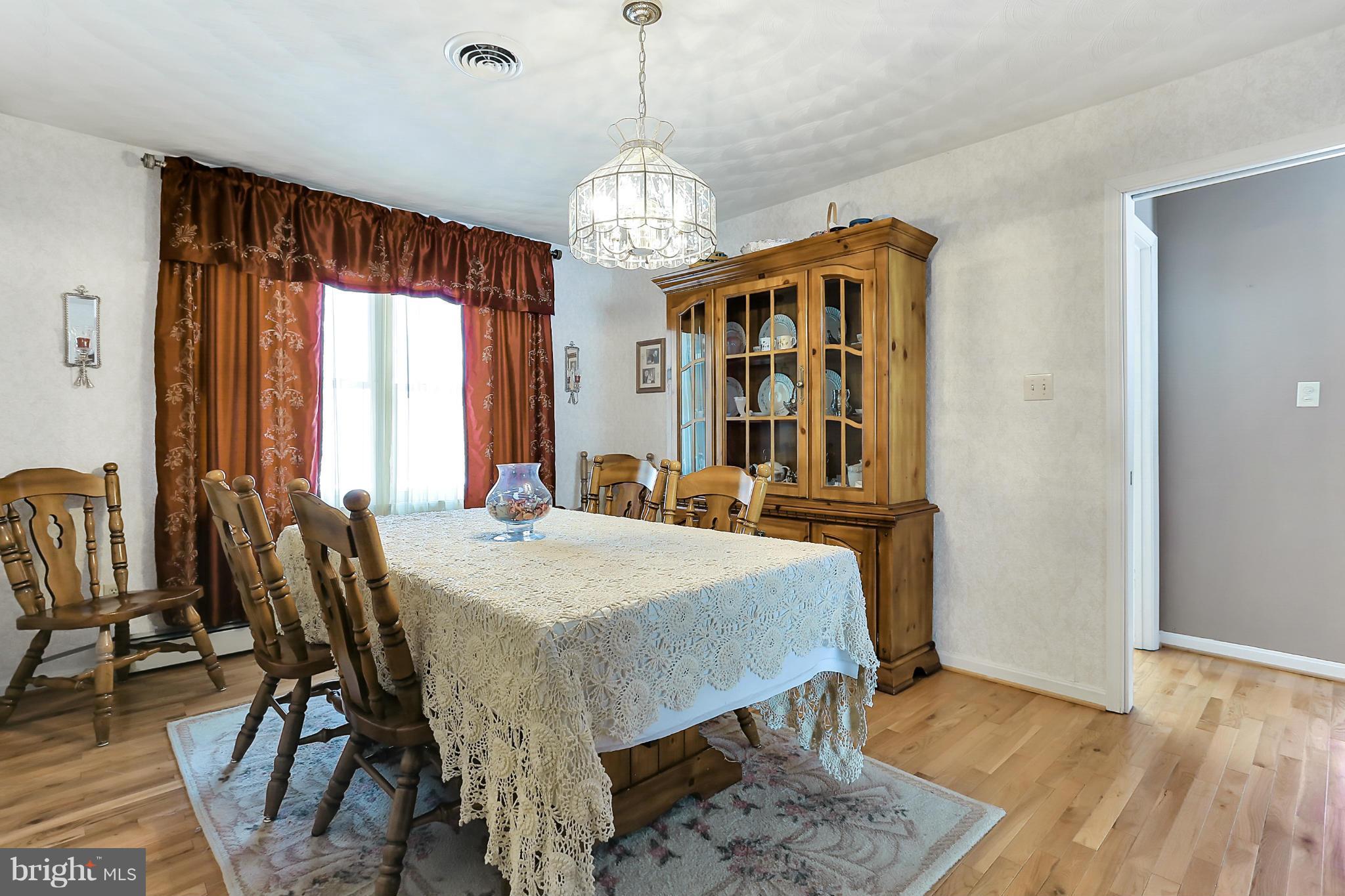 10852 Garrison Hollow Road Clear Spring, MD 21722 - Photo 8 of 30 a view of a dining room with furniture window and wooden floor