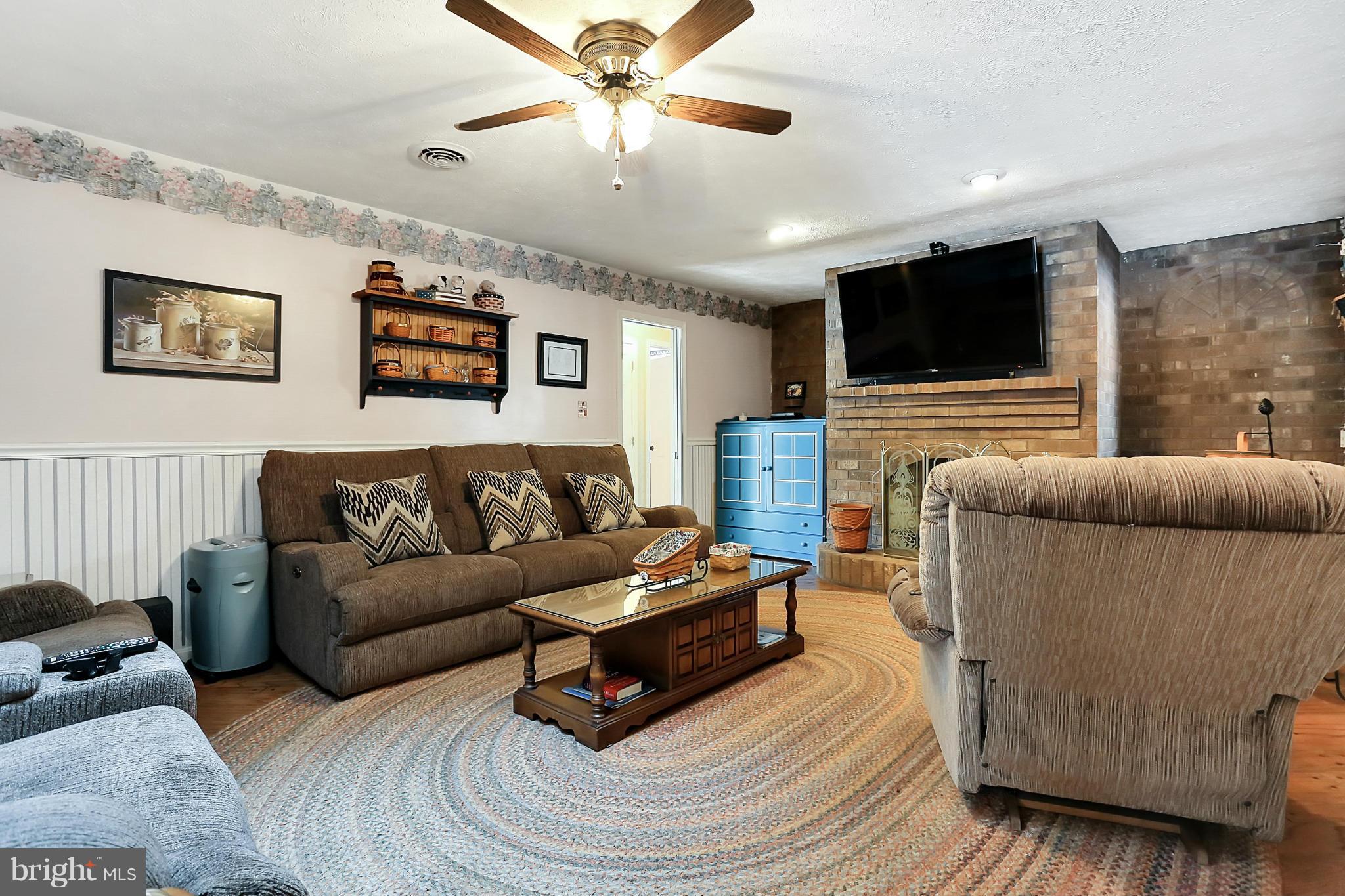 10852 Garrison Hollow Road Clear Spring, MD 21722 - Photo 9 of 30 a living room with furniture and a flat screen tv