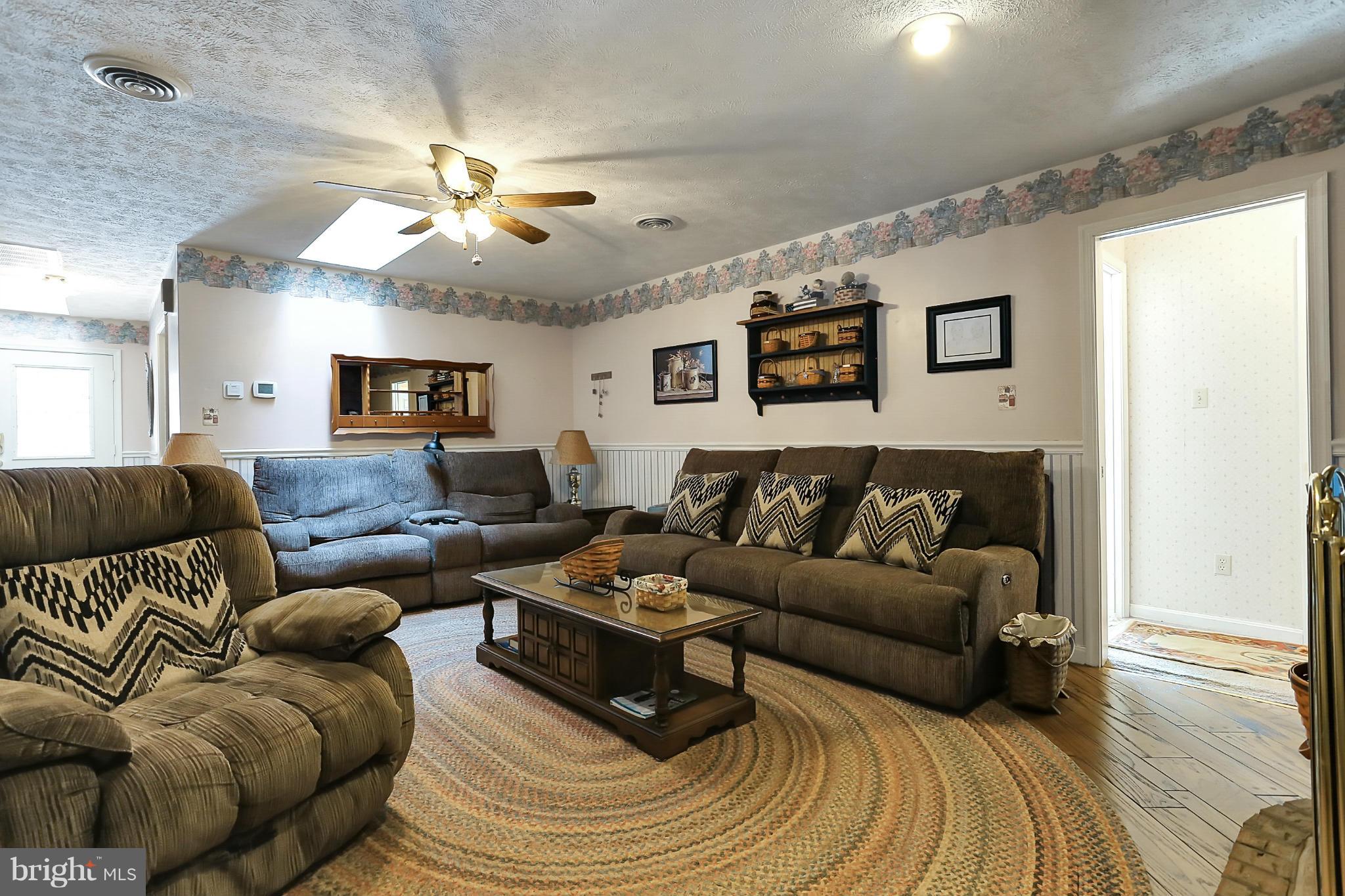10852 Garrison Hollow Road Clear Spring, MD 21722 - Photo 10 of 30 a living room with furniture and a chandelier