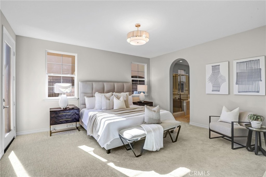 8 Ingleside Irvine, CA 92620 - Photo 21 of 74 a spacious bedroom with a bed and a chandelier