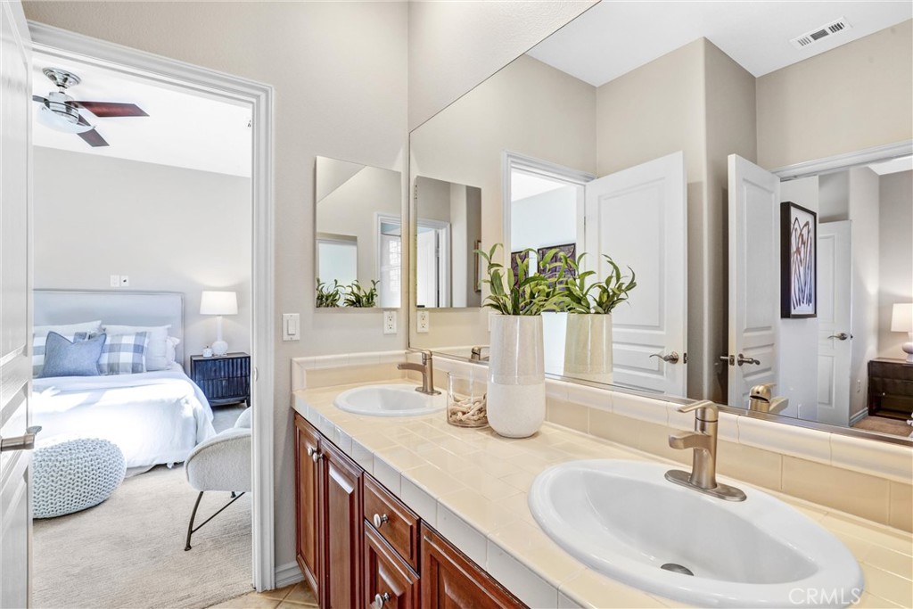 8 Ingleside Irvine, CA 92620 - Photo 37 of 74 a bathroom with a double vanity sink and a mirror