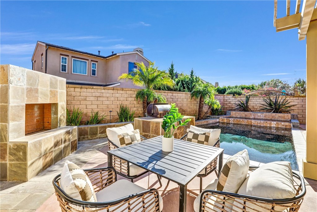 8 Ingleside Irvine, CA 92620 - Photo 43 of 74 a view of a patio with table and chairs potted plants with wooden floor and outdoor seating