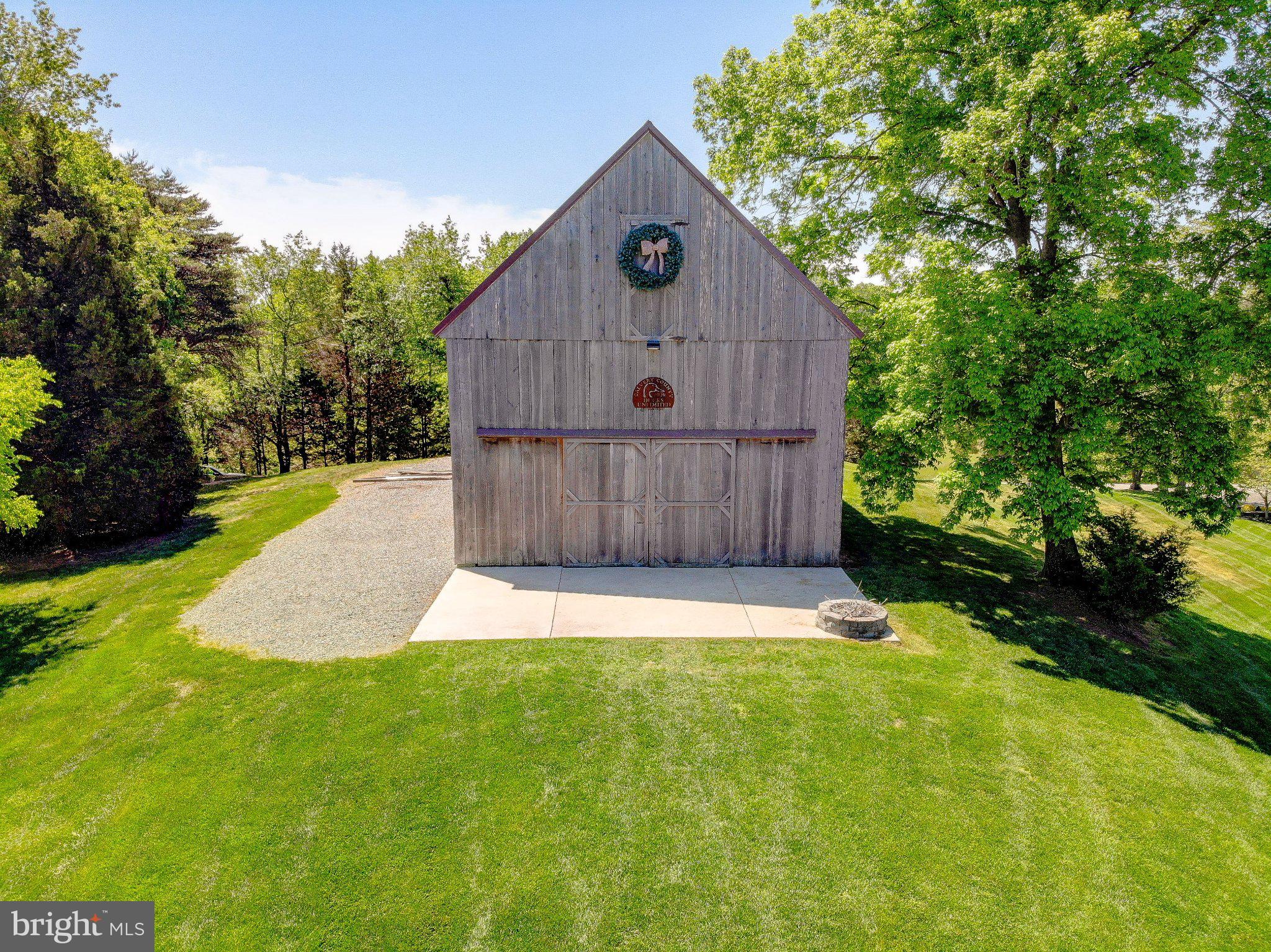 2393 Garrity Road St. Leonard, MD 20685 - Photo 6 of 14 Charming barn nestled in lush greenery.