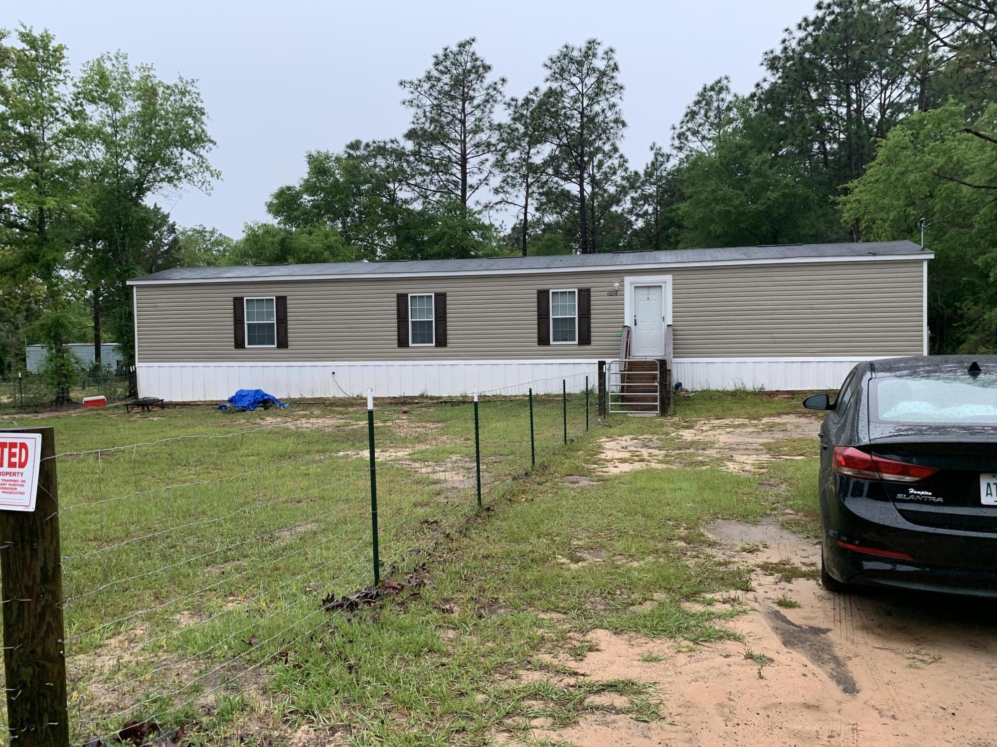 6214 Barnes Road Crestview, FL 32536 - Photo 21 of 23 a backyard of a house with barbeque oven table and chairs