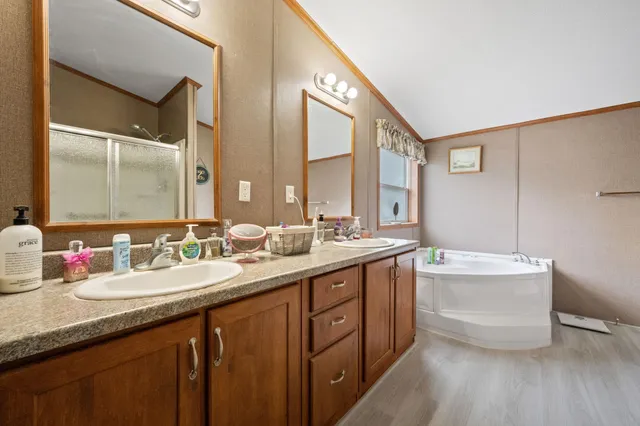 a bathroom with a double vanity sink mirror double and bathtub