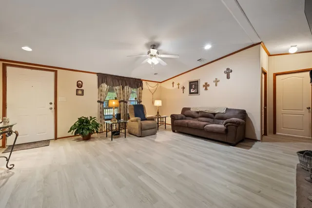 a living room with furniture and wooden floor