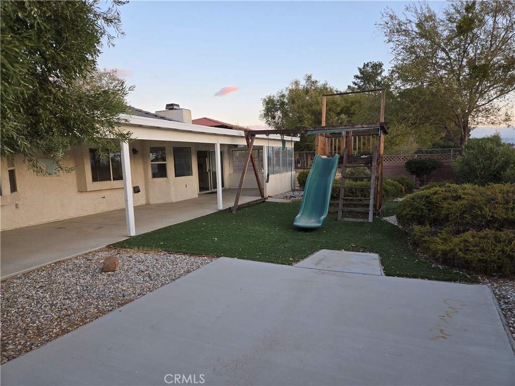 19345 Oneida Road Apple Valley, CA 92307 - Photo 14 of 19 a view of a house with yard and a garden