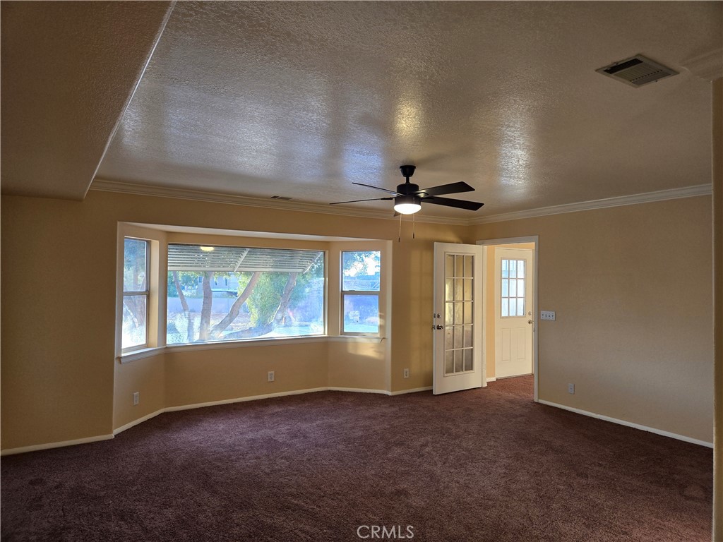 19345 Oneida Road Apple Valley, CA 92307 - Photo 3 of 19 an empty room with windows and fan