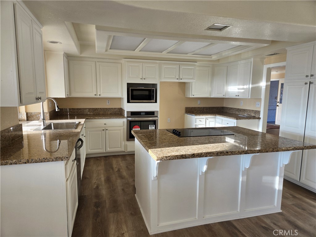 19345 Oneida Road Apple Valley, CA 92307 - Photo 9 of 19 a kitchen with stainless steel appliances granite countertop a sink and a stove