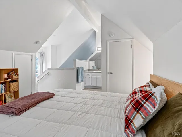 a bedroom with a bed and cabinets