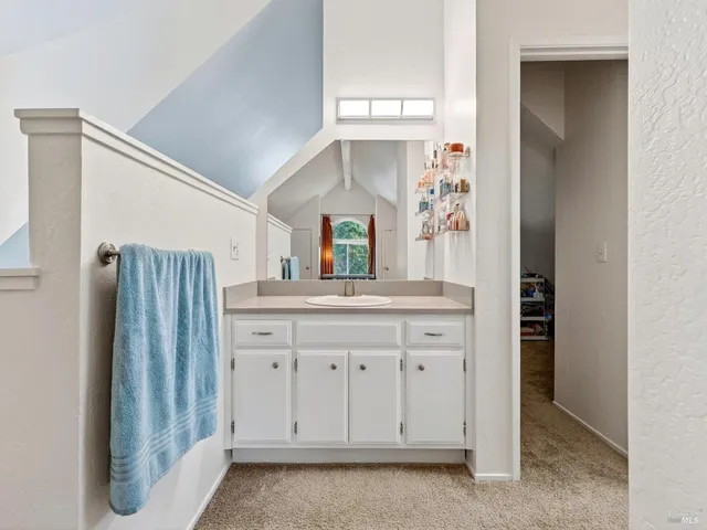 a bathroom with a sink a vanity and a mirror