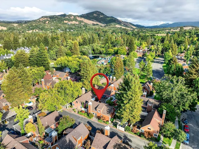 an aerial view of residential houses with outdoor space and street view