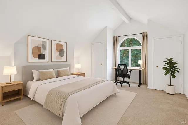 a bedroom with a bed and a large window