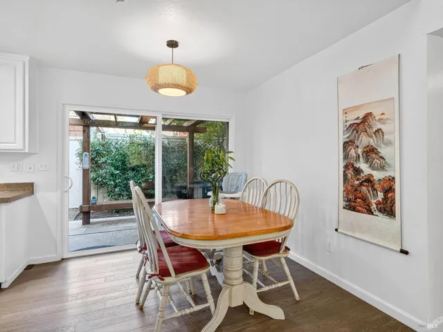 a dining room with furniture and wooden floor