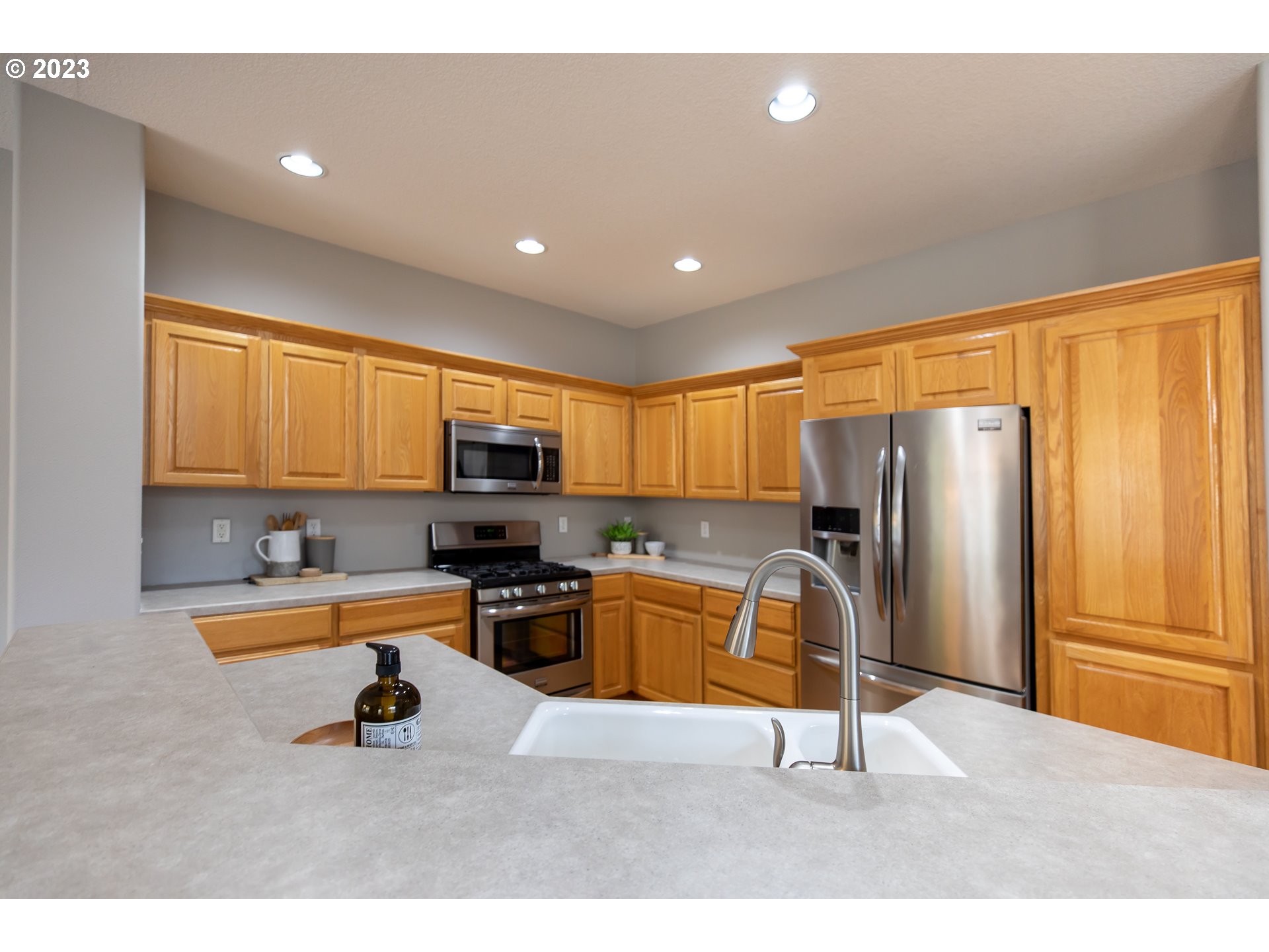 2399 Southwest Border Way Gresham, OR 97080 - Photo 12 of 48 a kitchen with a refrigerator and a sink