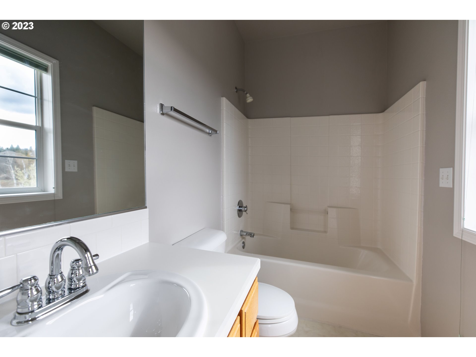 2399 Southwest Border Way Gresham, OR 97080 - Photo 35 of 48 a bathroom with a tub sink and mirror