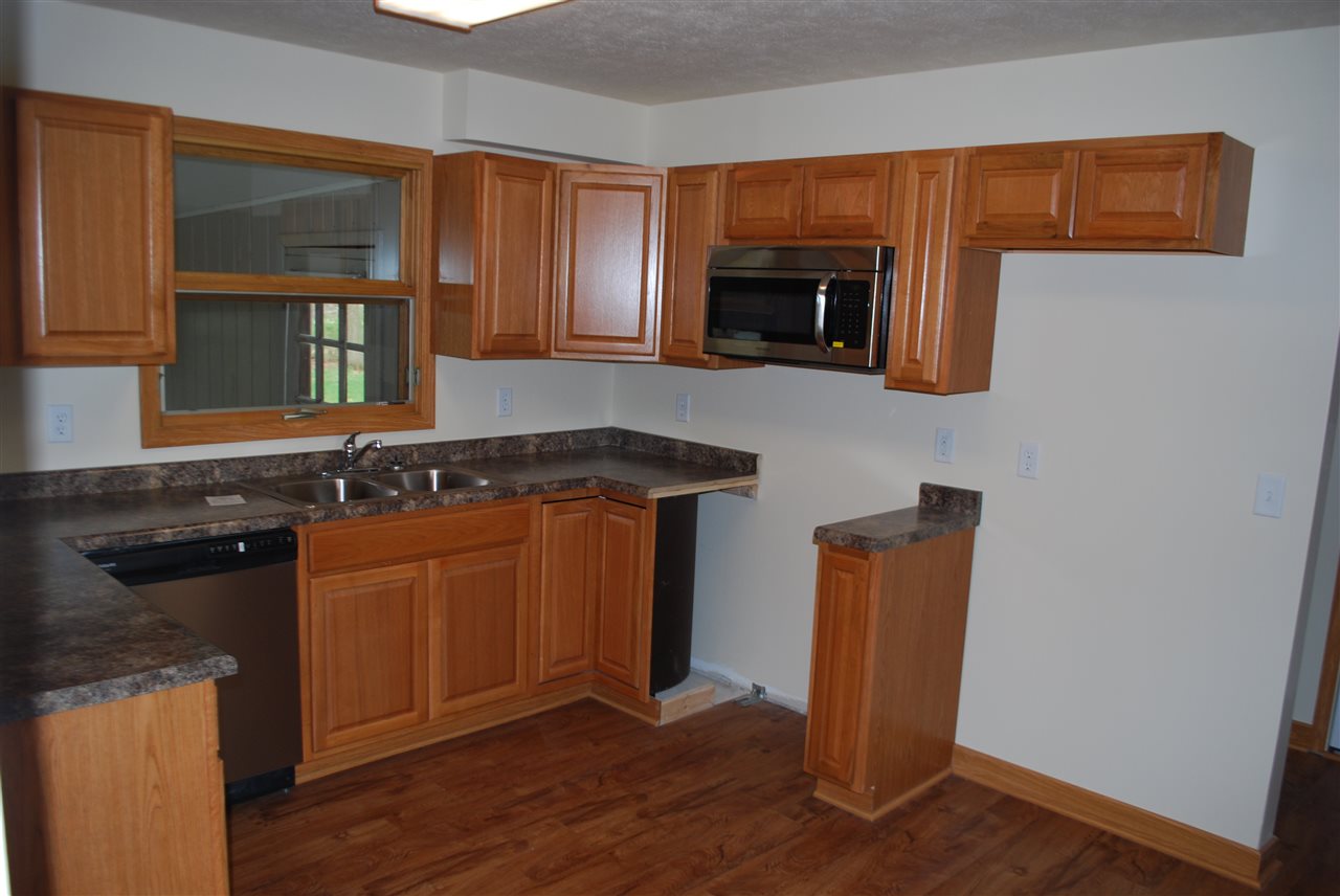 7941 Fairdale Road Cherry Valley, IL 61016 - Photo 11 of 18 a kitchen with stainless steel appliances granite countertop a stove a sink and a microwave