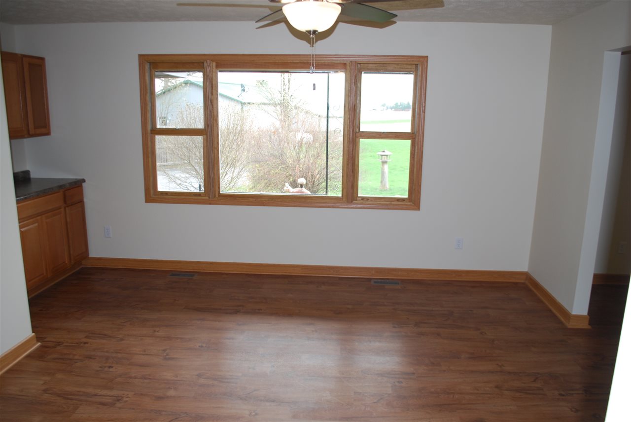 7941 Fairdale Road Cherry Valley, IL 61016 - Photo 3 of 18 an empty room with wooden floor and windows