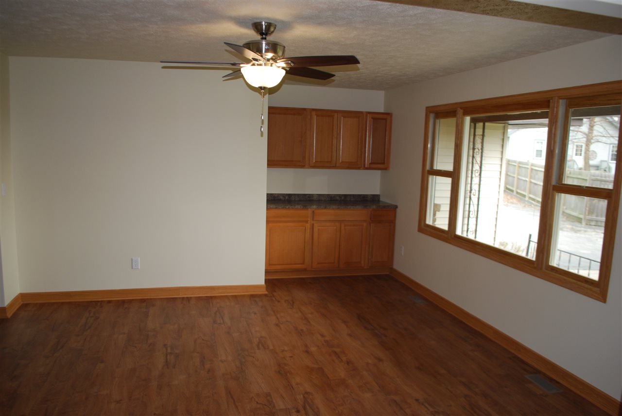 7941 Fairdale Road Cherry Valley, IL 61016 - Photo 4 of 18 an empty room with wooden floor and windows