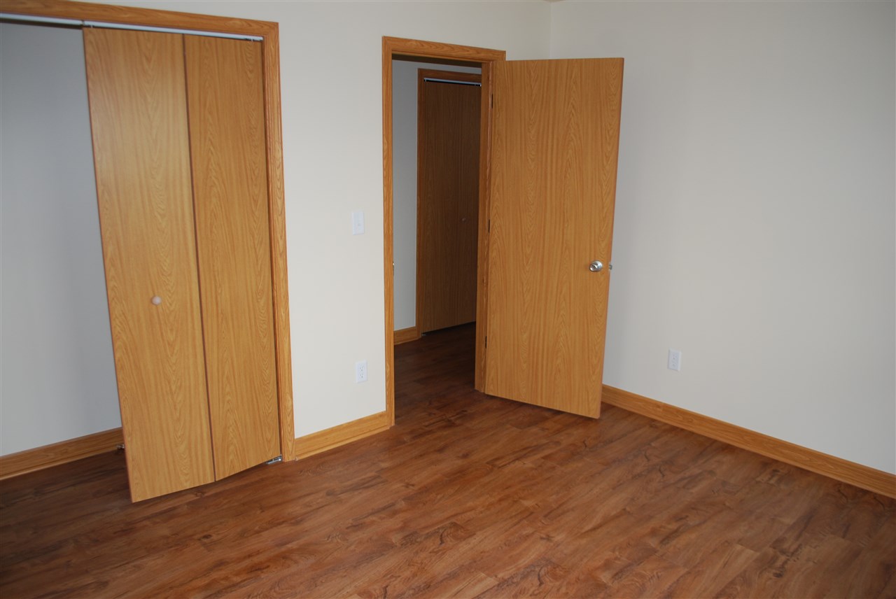 7941 Fairdale Road Cherry Valley, IL 61016 - Photo 7 of 18 a view of an empty room with wooden floor and closet
