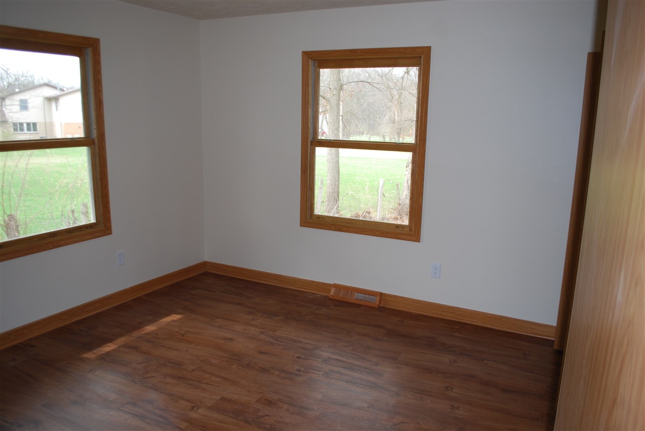 7941 Fairdale Road Cherry Valley, IL 61016 - Photo 9 of 18 an empty room with wooden floor and windows