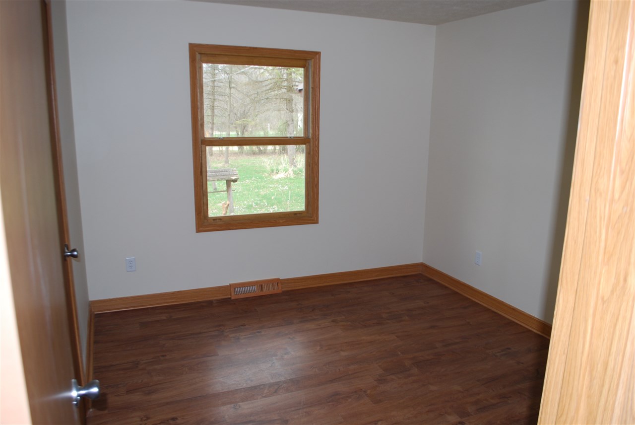 7941 Fairdale Road Cherry Valley, IL 61016 - Photo 10 of 18 an empty room with wooden floor and windows