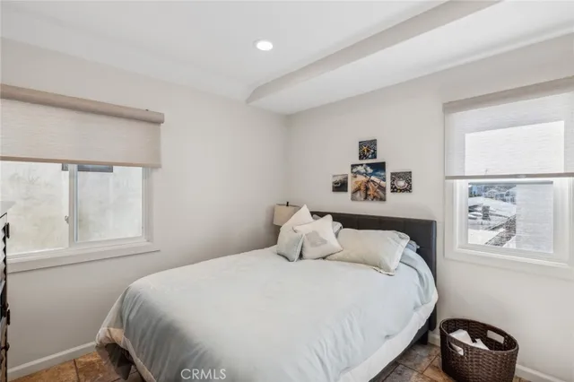 a spacious bedroom with a bed and a fireplace