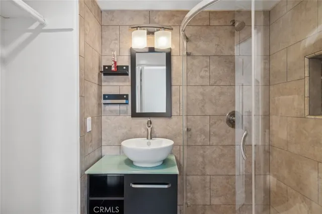 a bathroom with a tub sink and mirror