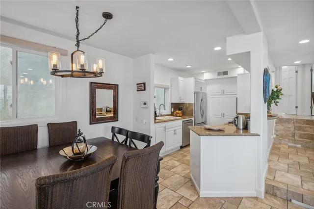 a living room with furniture a fireplace and a floor to ceiling window