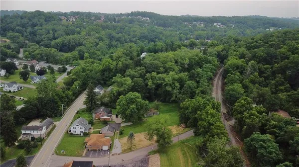 an aerial view of a forest with houses