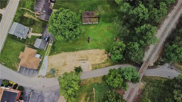 an aerial view of a house with outdoor space and street view