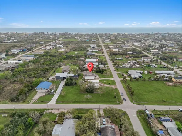 an aerial view of residential houses with outdoor space and swimming pool