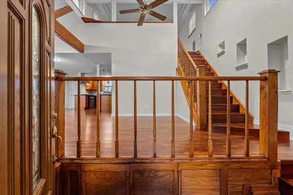 a view of staircase with railing and white walls