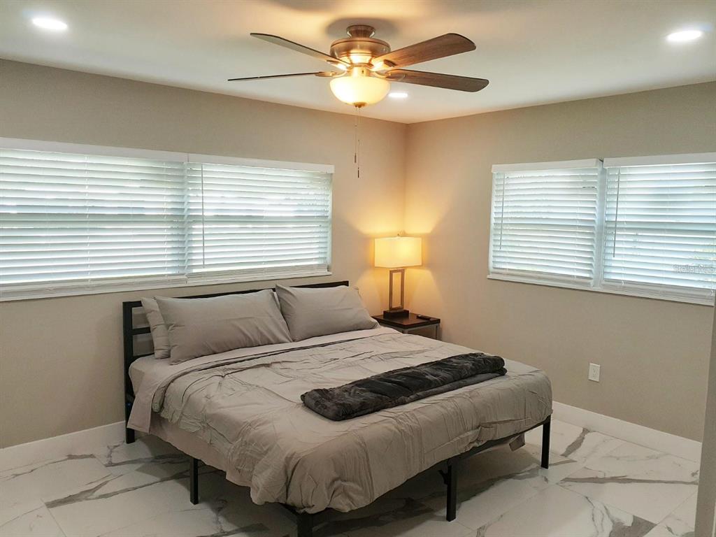 2042 Craft Lane Sarasota, FL 34239 - Photo 14 of 100 a bedroom with a bed and a chandelier