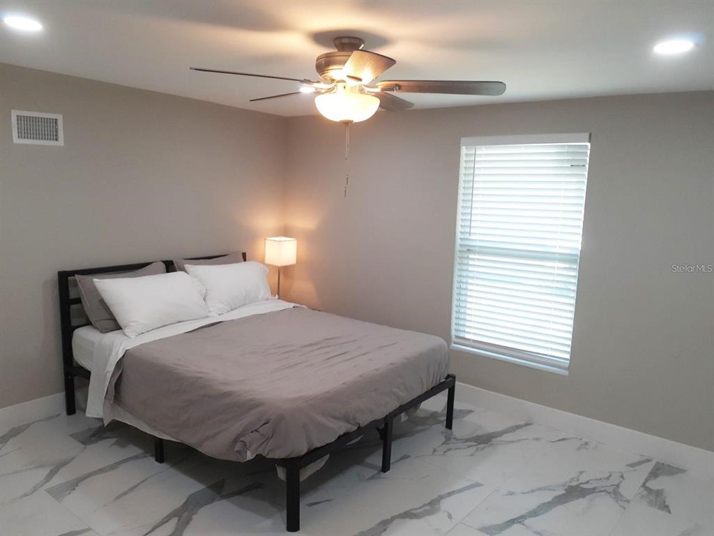 2042 Craft Lane Sarasota, FL 34239 - Photo 15 of 100 a bedroom with a bed and a chandelier
