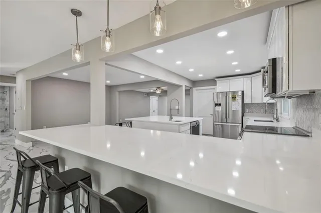 a living room with furniture a large window and a table