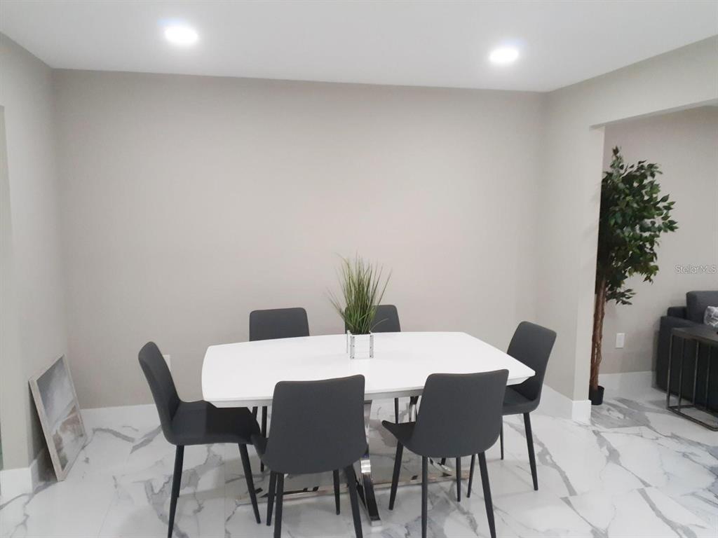 2042 Craft Lane Sarasota, FL 34239 - Photo 23 of 100 a view of a dining room with furniture and wooden floor