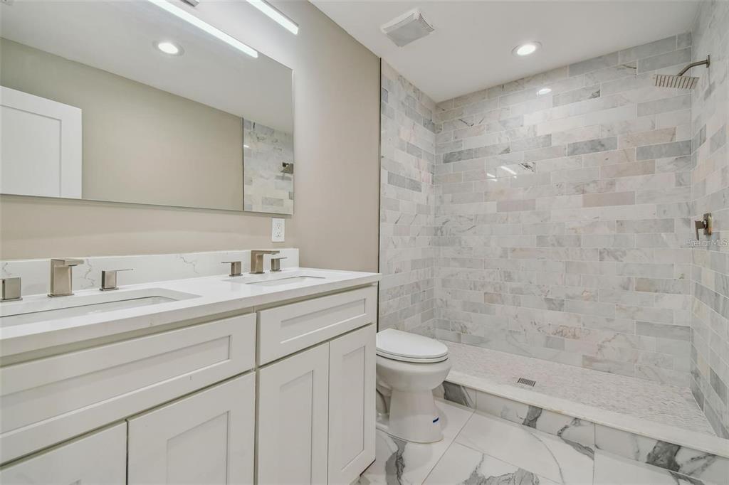 2042 Craft Lane Sarasota, FL 34239 - Photo 28 of 100 a bathroom with a sink a toilet and shower