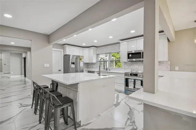 a bedroom with a large bed and a large window