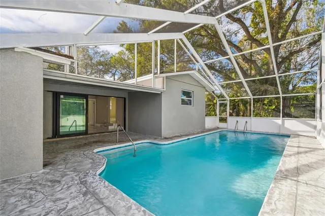 a living room with furniture a chandelier and a dining table