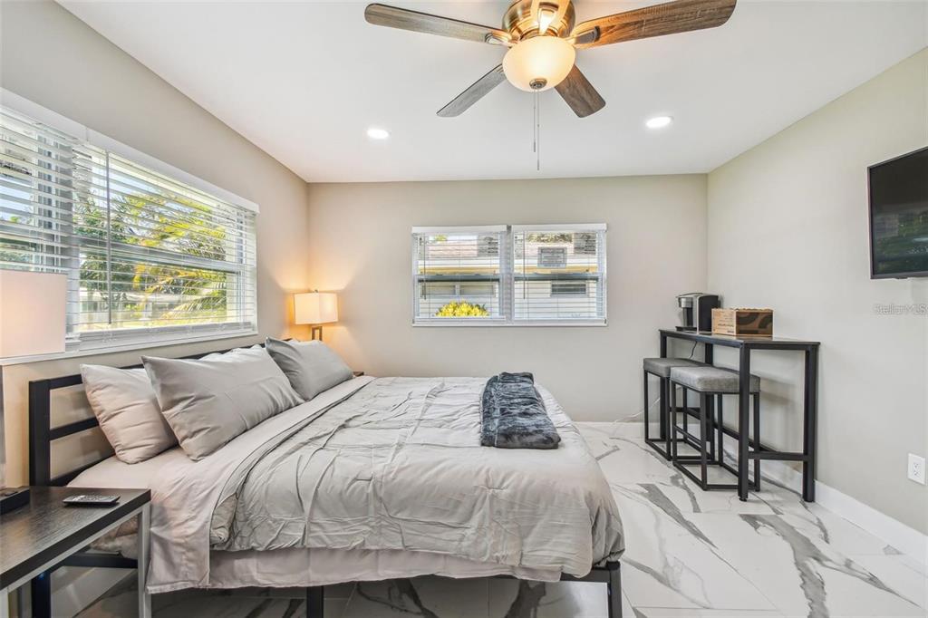 2042 Craft Lane Sarasota, FL 34239 - Photo 53 of 100 a bedroom with a bed and a chandelier