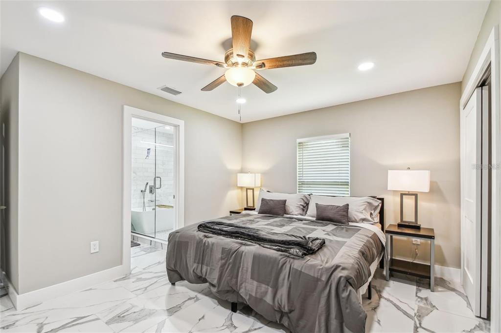 2042 Craft Lane Sarasota, FL 34239 - Photo 56 of 100 a bedroom with a bed and a chandelier