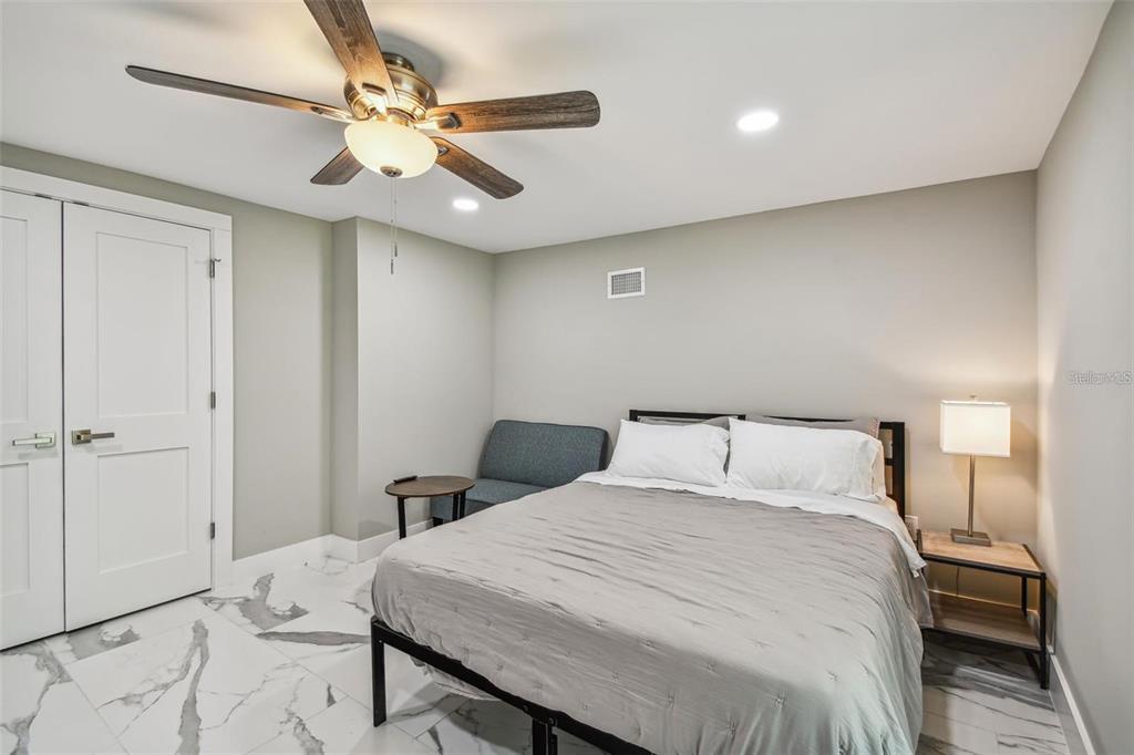 2042 Craft Lane Sarasota, FL 34239 - Photo 59 of 100 a bedroom with a bed and a chandelier