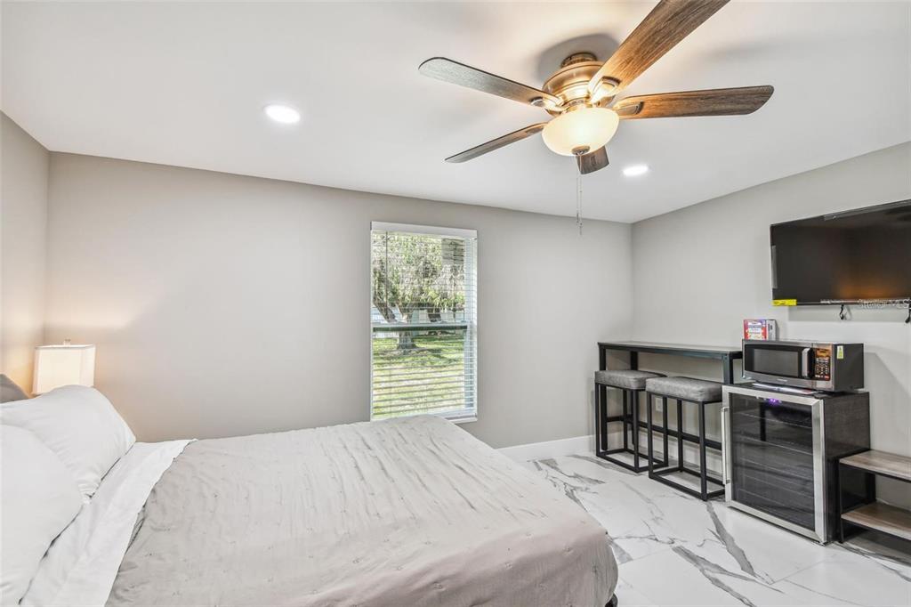 2042 Craft Lane Sarasota, FL 34239 - Photo 60 of 100 a bedroom with a bed and a flat screen tv