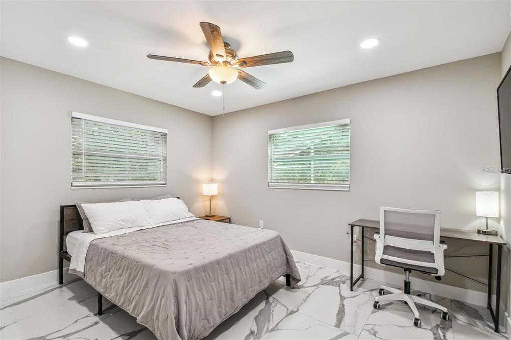 2042 Craft Lane Sarasota, FL 34239 - Photo 67 of 100 a bedroom with a large bed and a window