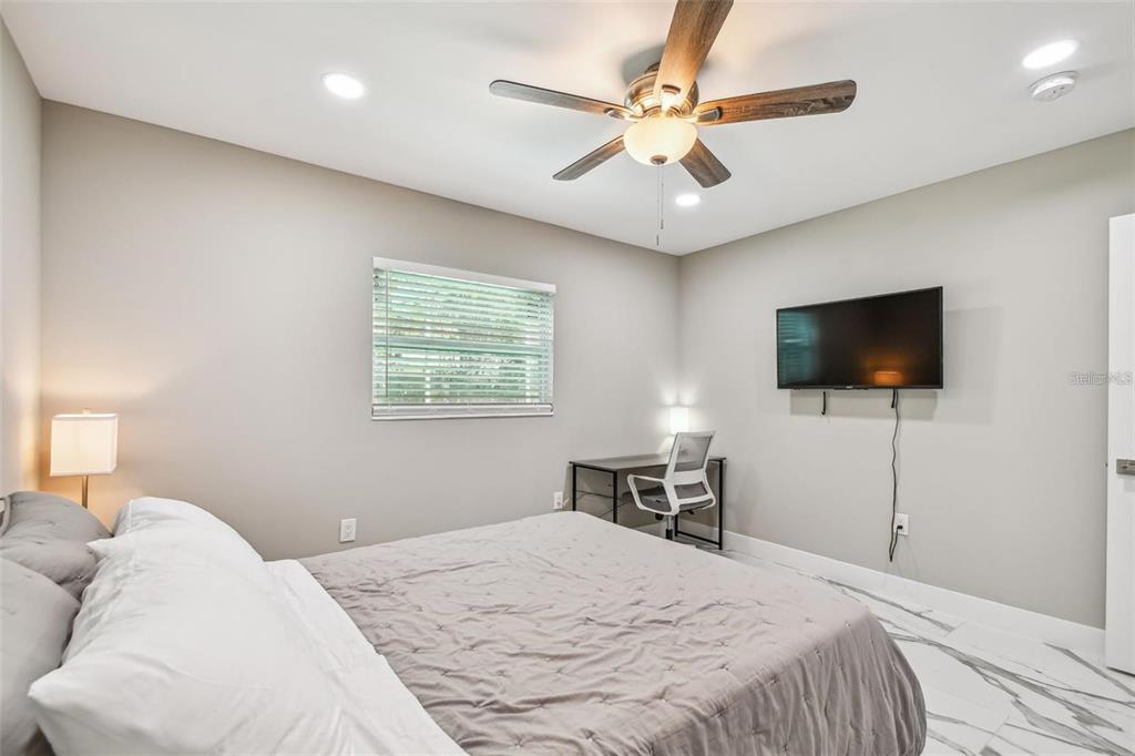2042 Craft Lane Sarasota, FL 34239 - Photo 68 of 100 a bedroom with a bed and a flat screen tv