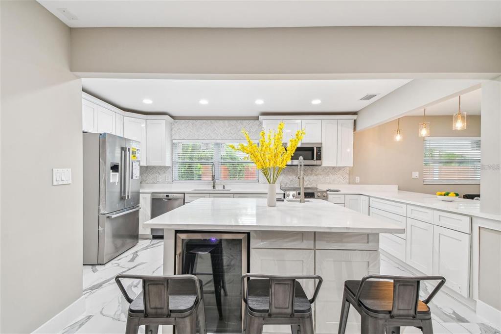 2042 Craft Lane Sarasota, FL 34239 - Photo 71 of 100 a kitchen with stainless steel appliances a sink and a refrigerator