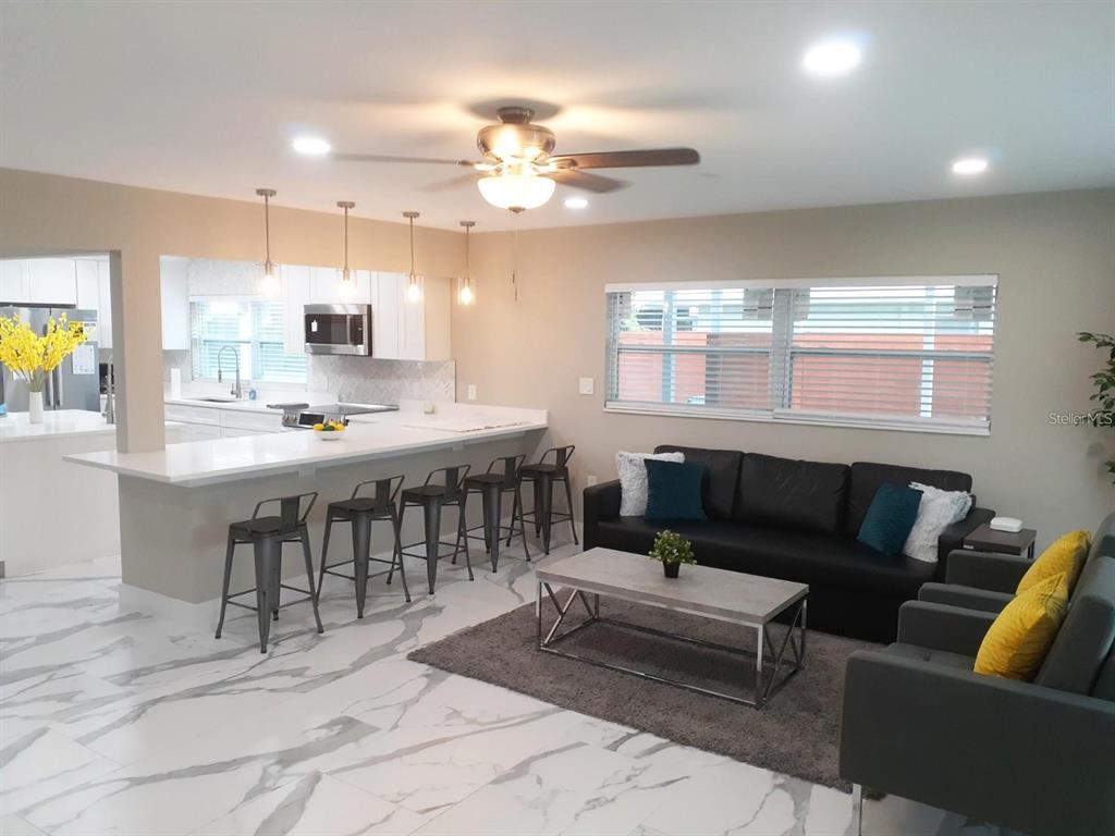 2042 Craft Lane Sarasota, FL 34239 - Photo 10 of 100 a living room with furniture a chandelier and a dining table