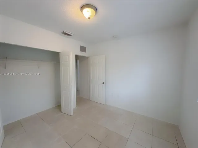 an empty room with a empty space and windows