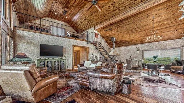 a view of a patio with couches table and chairs and wooden floor